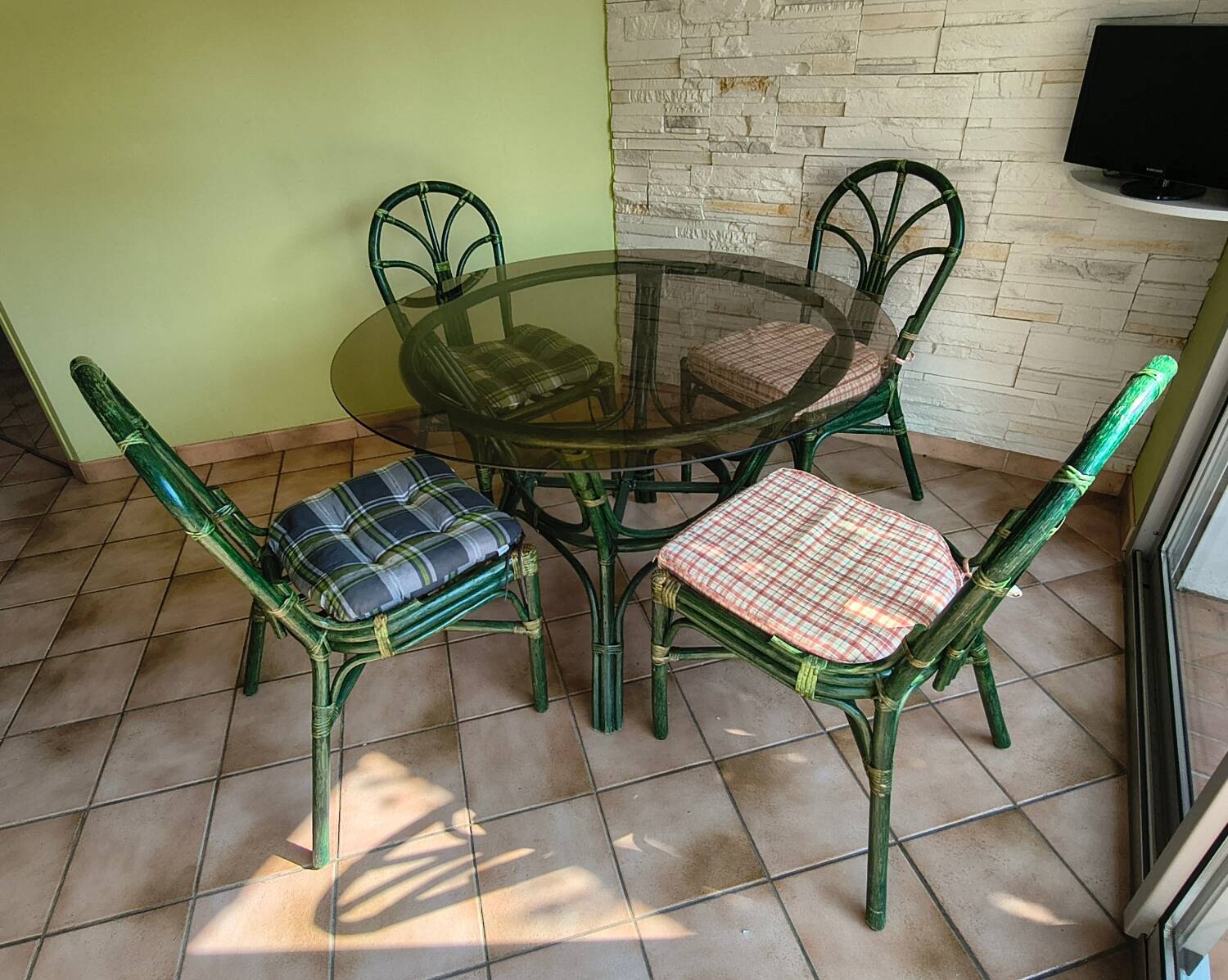Round bamboo rattan table with a glass top.