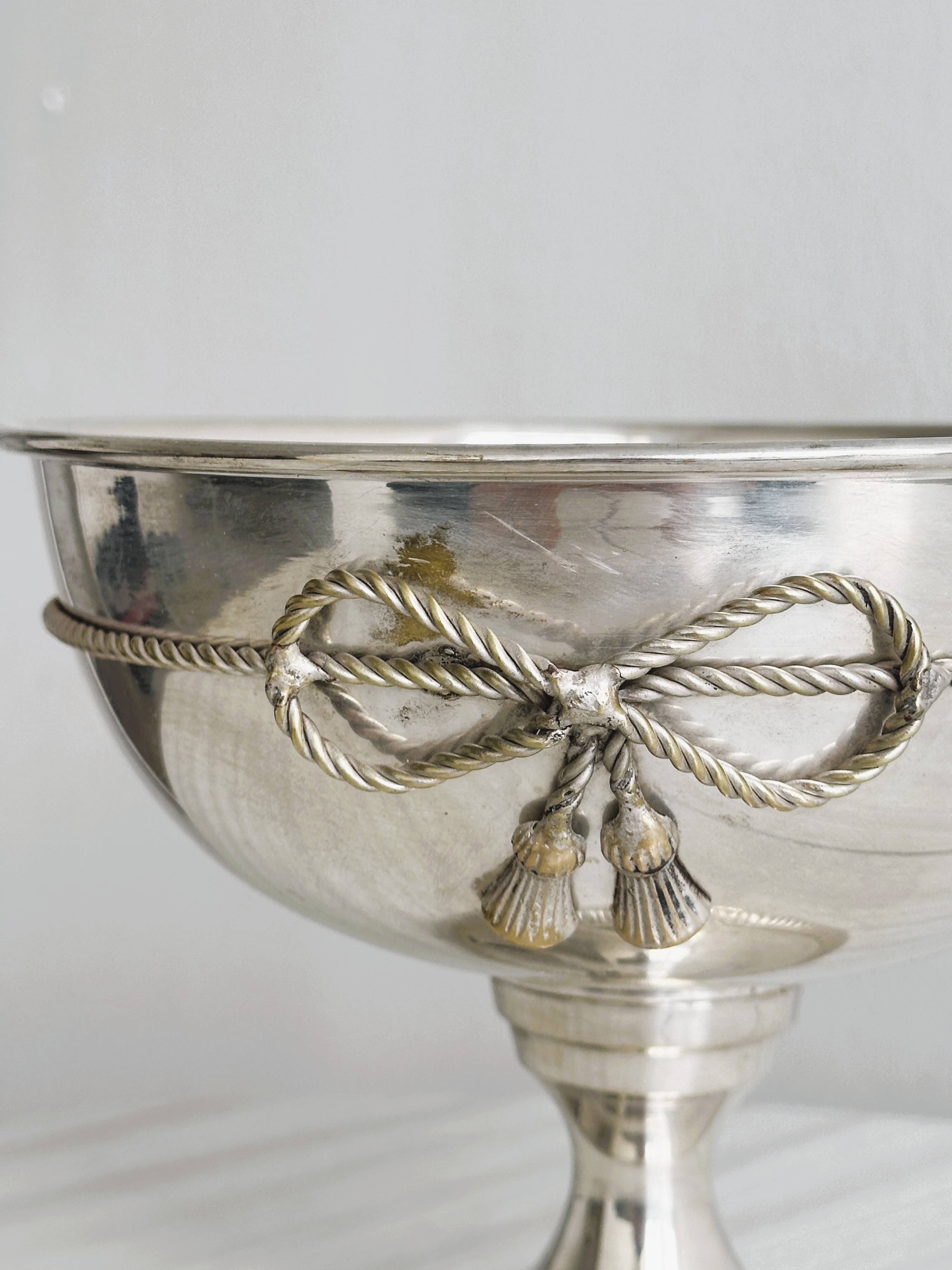 shiny silver metal cup on foot