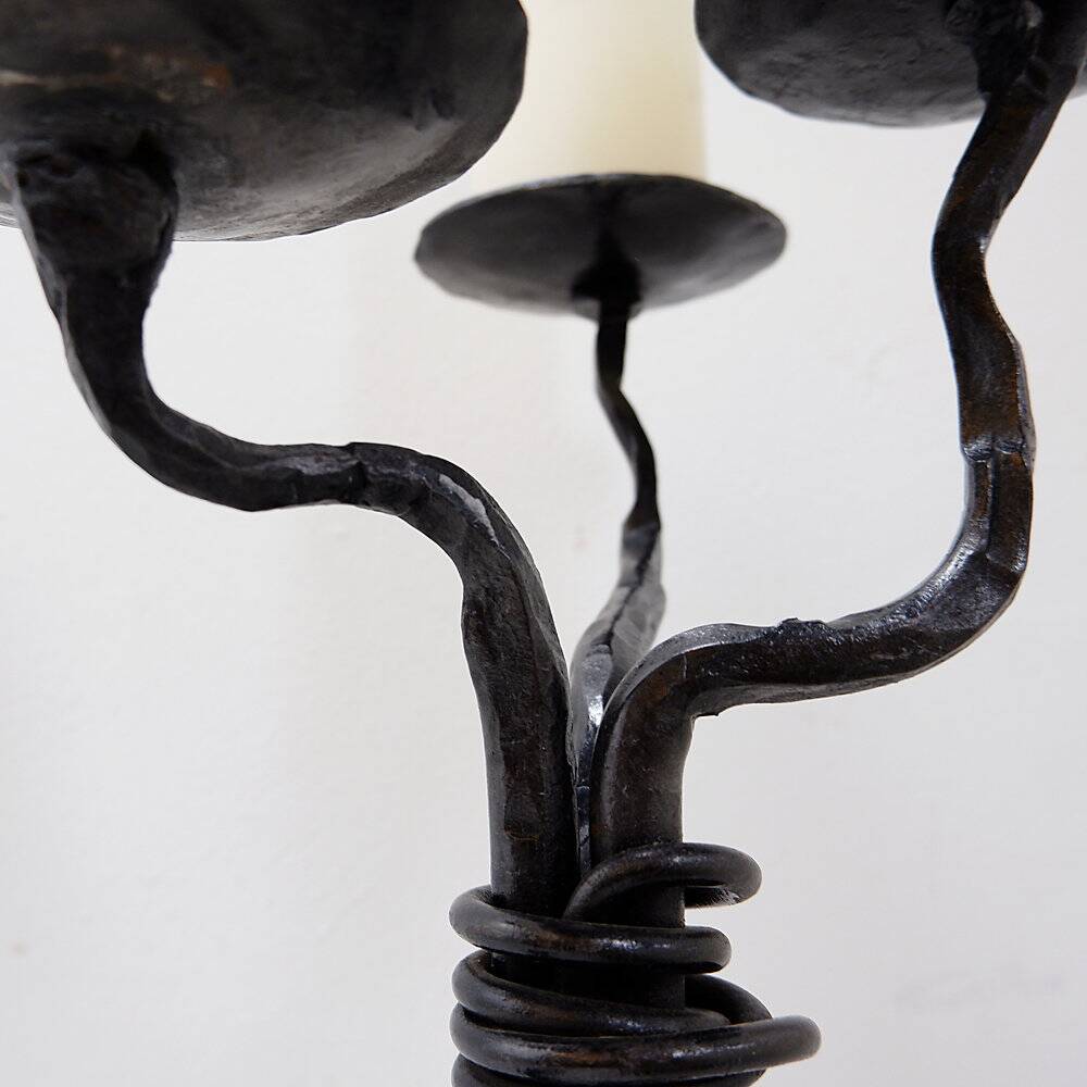 Large wrought iron candelabrum with an abstract design and three candle holders.