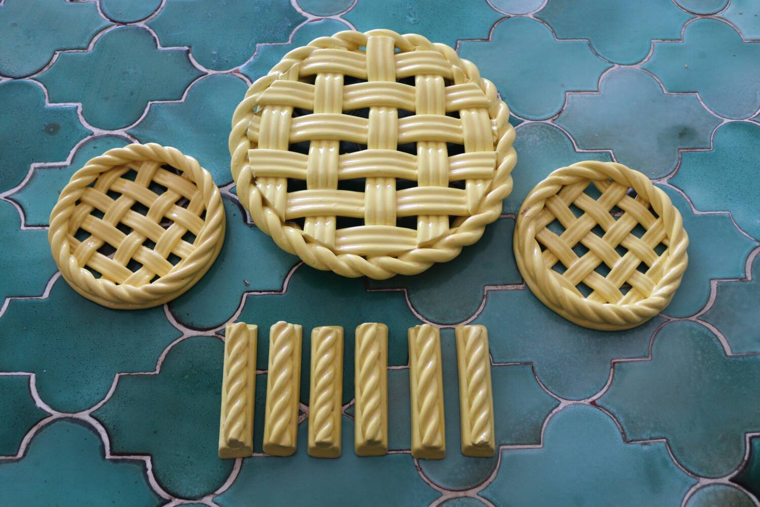 2 yellow ceramic trivets and knife rests