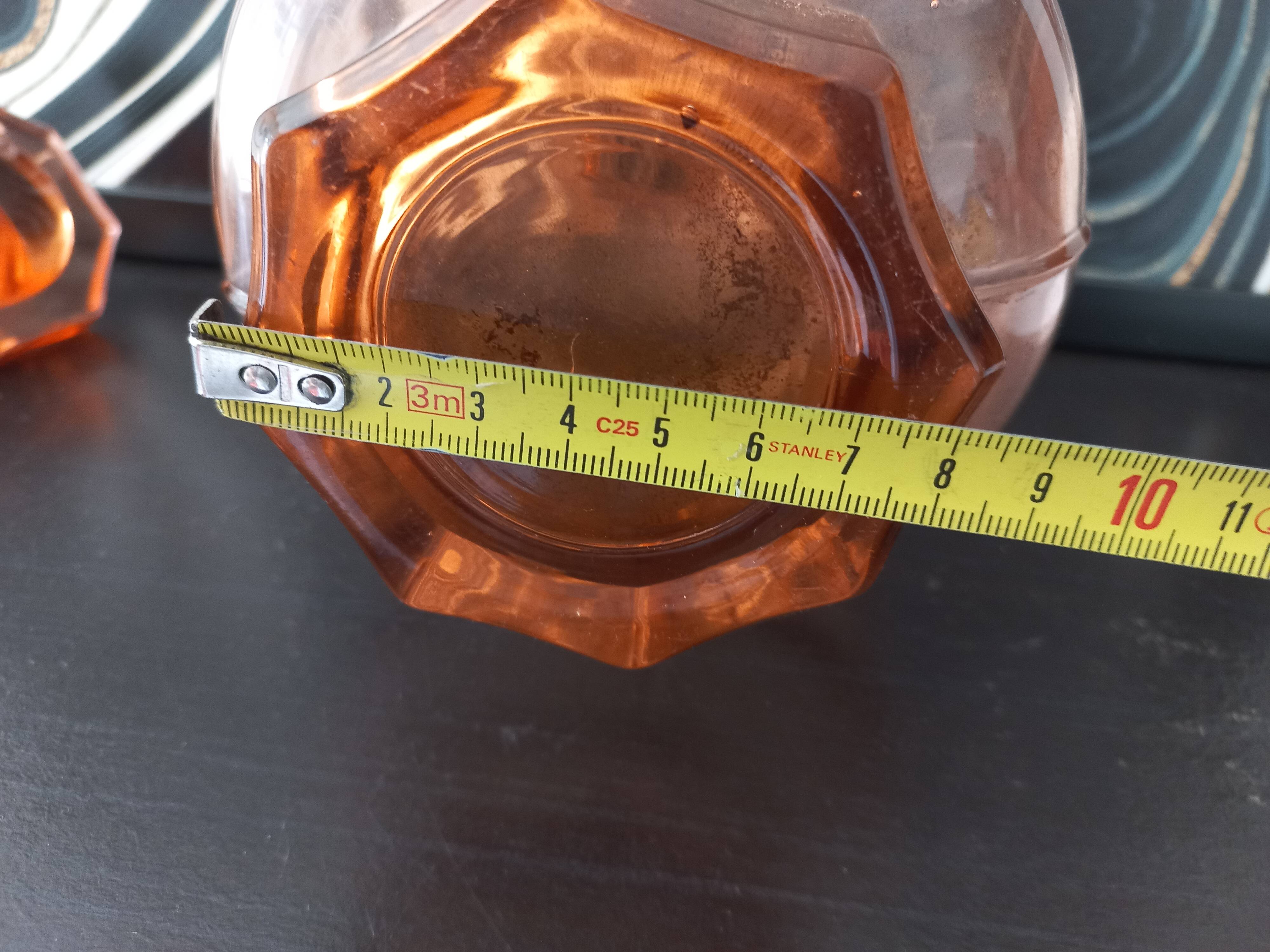 Vintage glass carafe in pink-orange, retro-chic style.