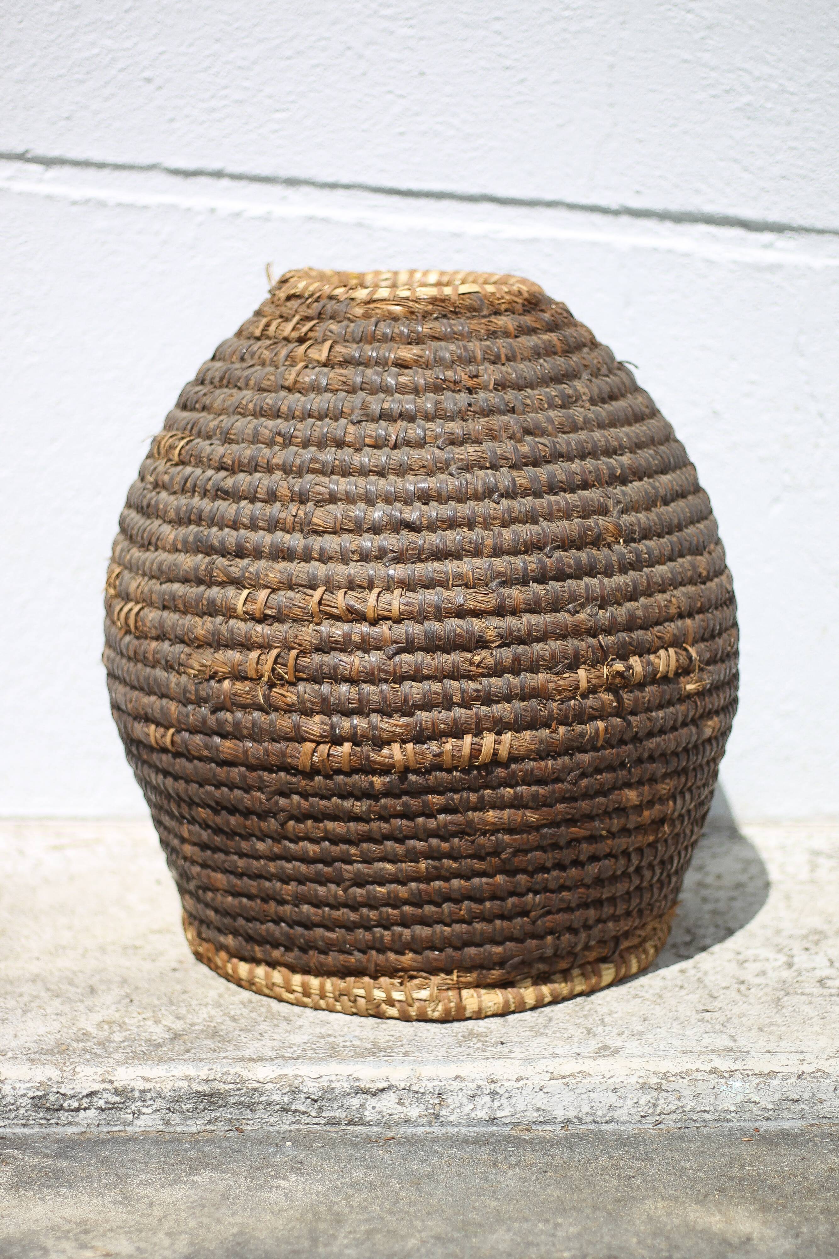 Old basket, burgundy straw and bramble, woven basket, interior decoration, pantry, flowerpot