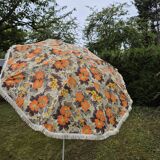 Vintage parasol in brown orange flower canvas with fringes on the edge