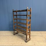 Old wooden workshop shelf with cast iron wheels.