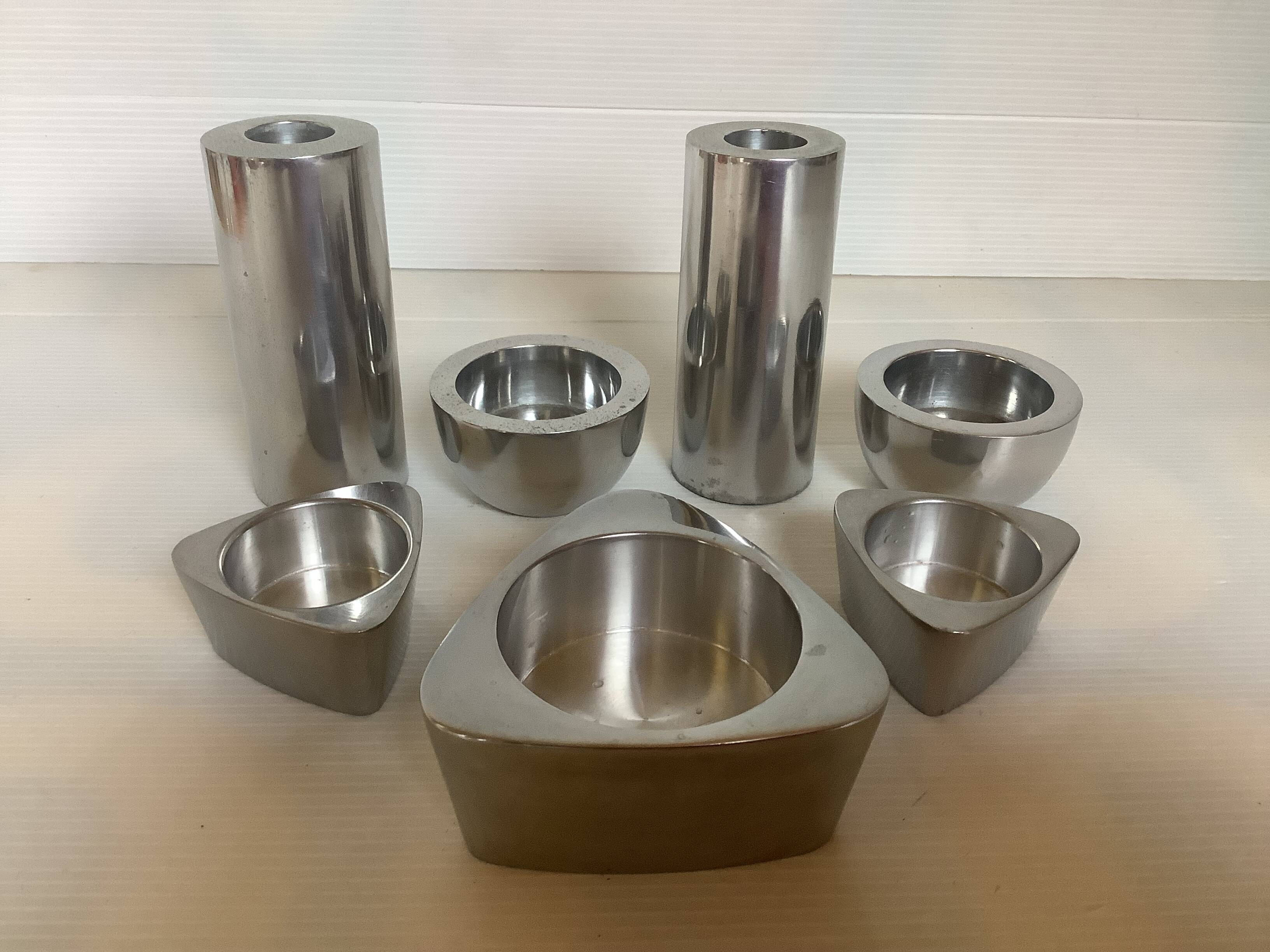 Seven different metal candle holders