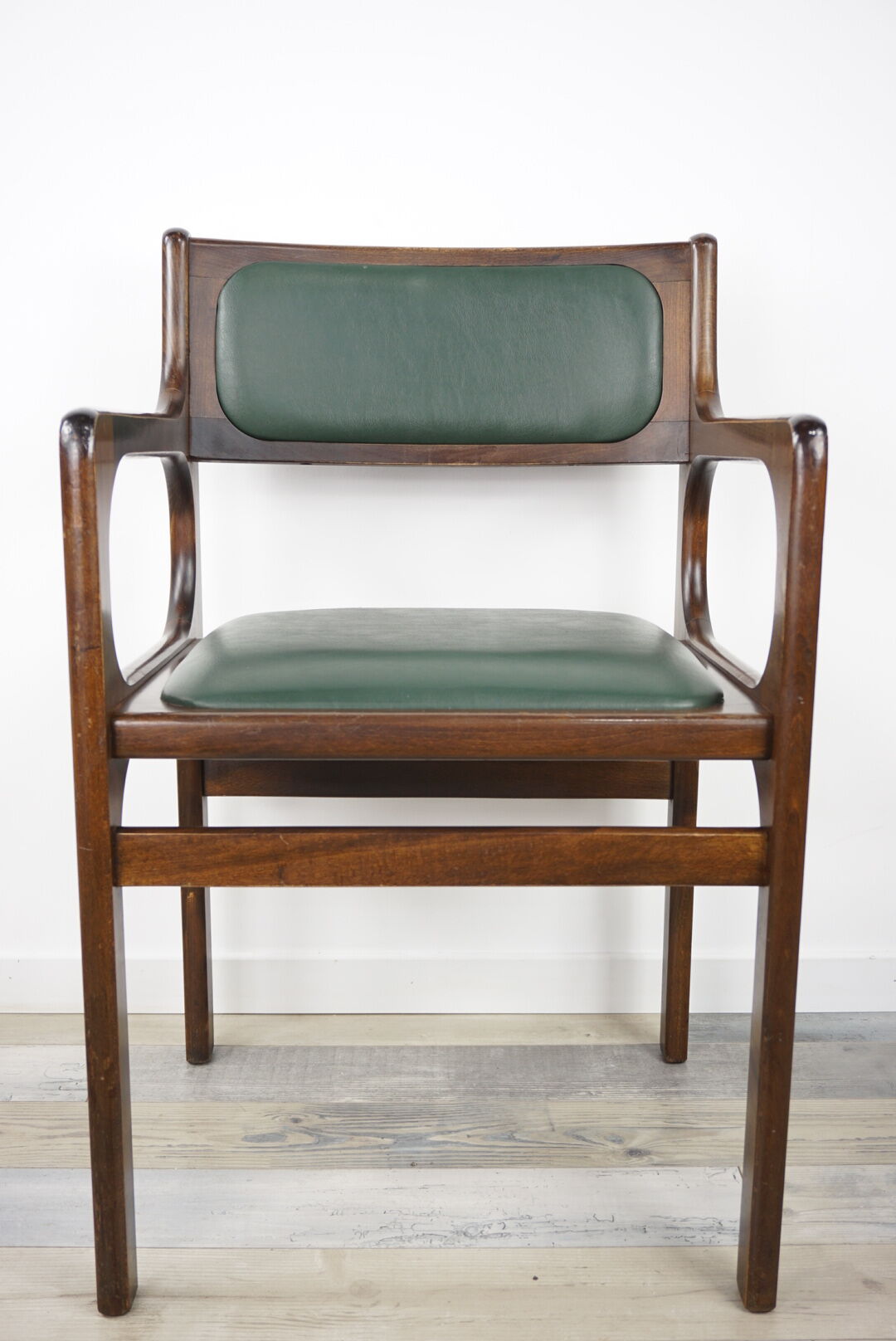 Armchair of the 60s in wood and imitation dark green leather