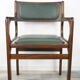 Armchair of the 60s in wood and imitation dark green leather