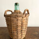 Demijohn surrounded by wicker