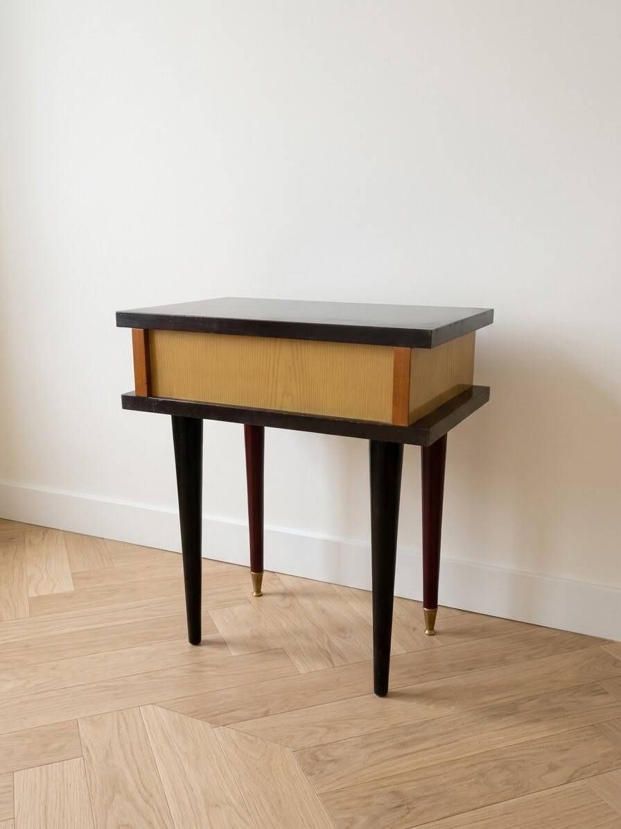 Vintage Art Deco bedside table in dark wood with gold details.