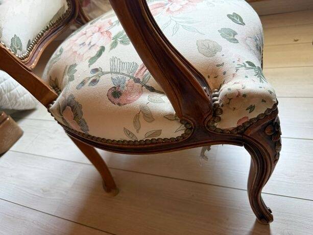 Louis XV style armchair upholstered in floral fabric.