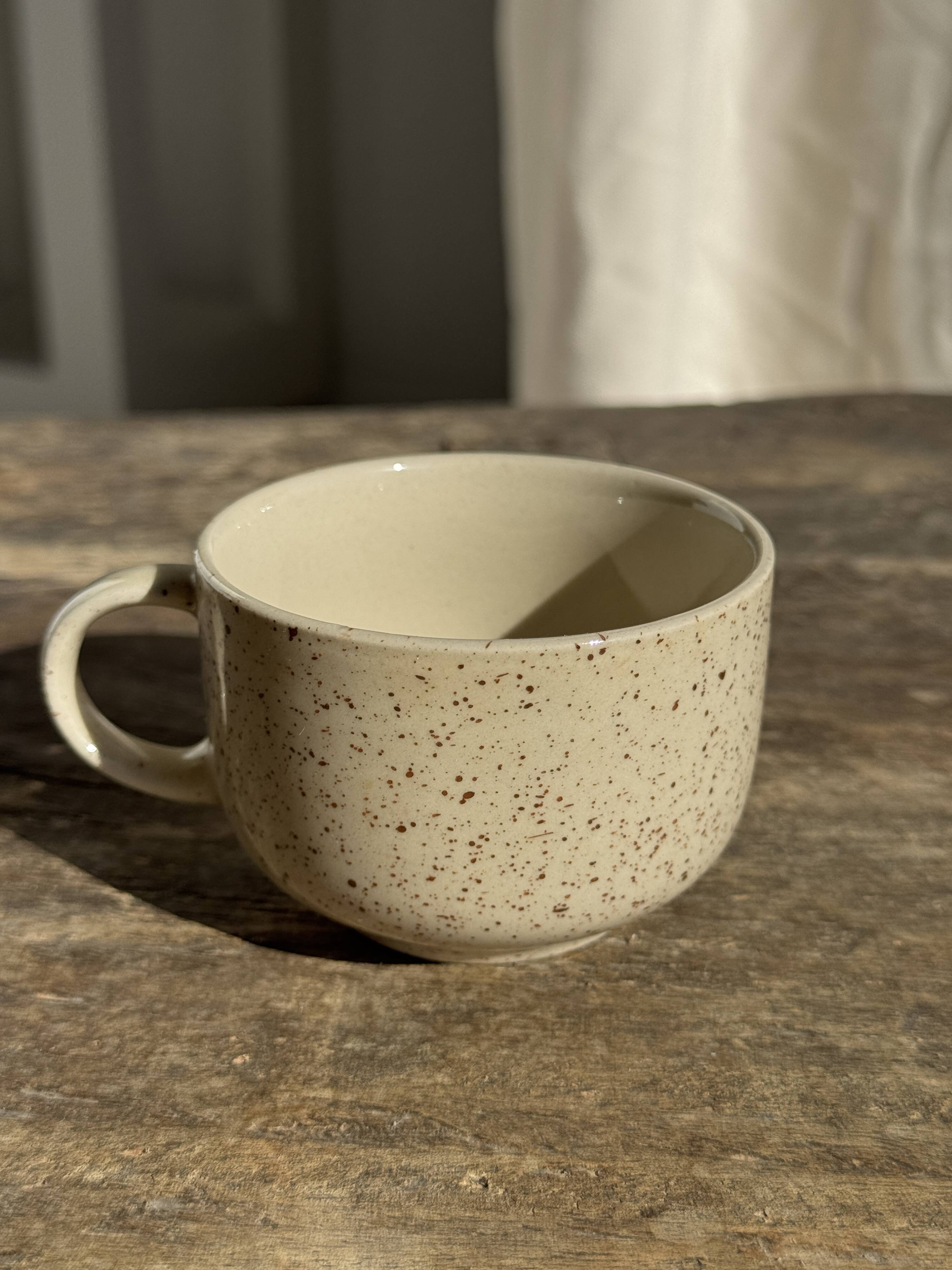 Set of 4 vintage speckled beige stoneware coffee cups.