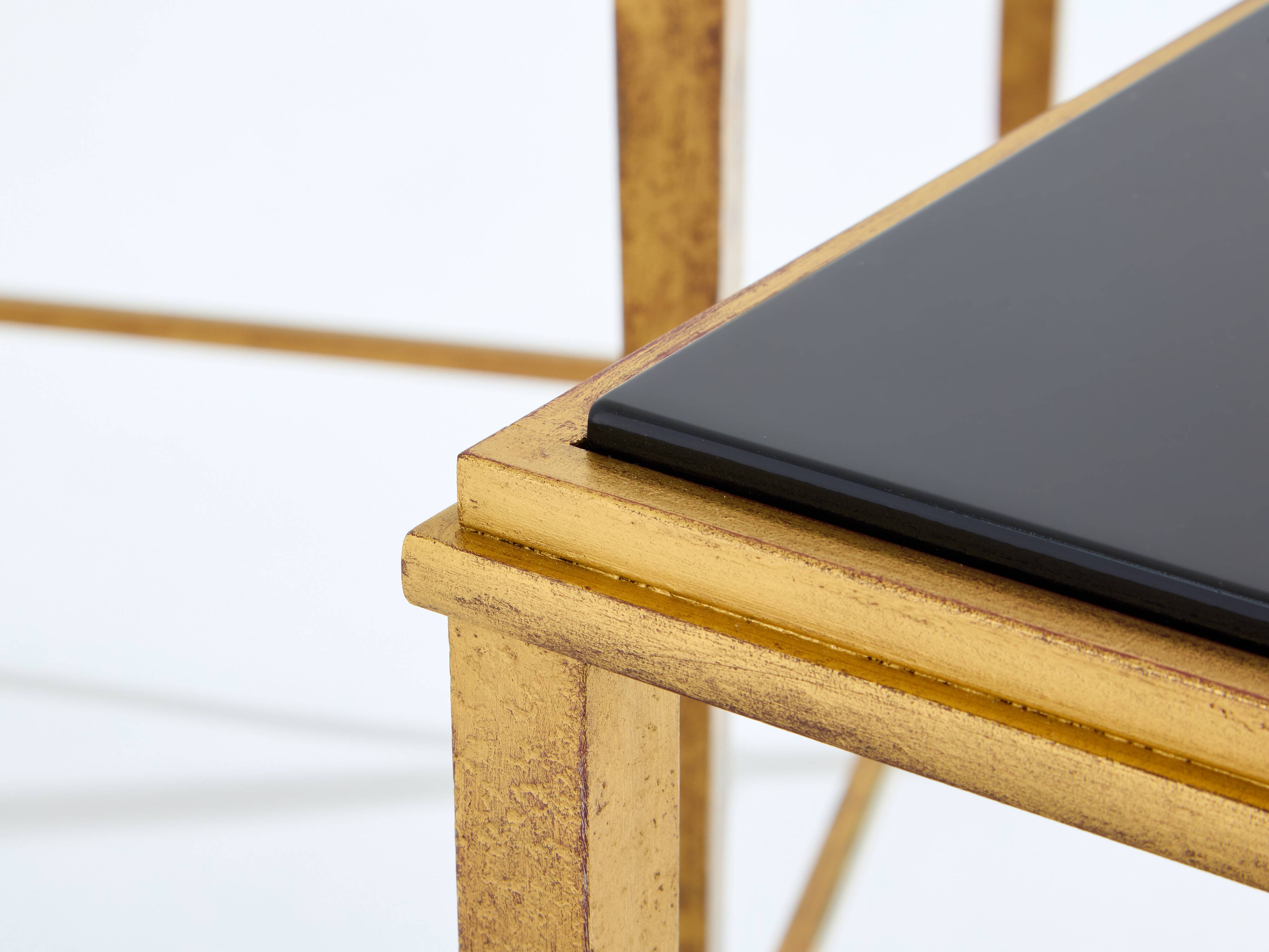 Pair of side tables in gilded iron and black lacquer Maison Ramsay 1950