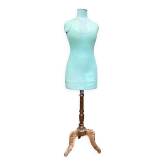 Old mannequin on wooden and fabric stand