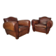 Important pair of Havana leather club armchairs, moustache models, mid-20th century.