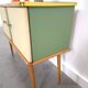 Vintage green DDR cabinet, model Libelle with glass top, slanted legs.