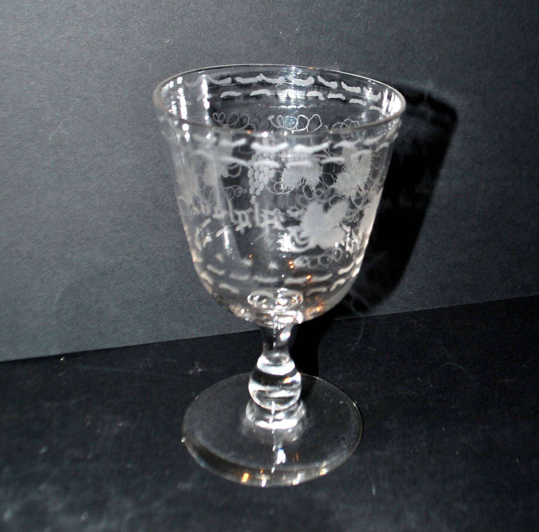 Antique souvenir glass tumbler engraved with the name Adolphe