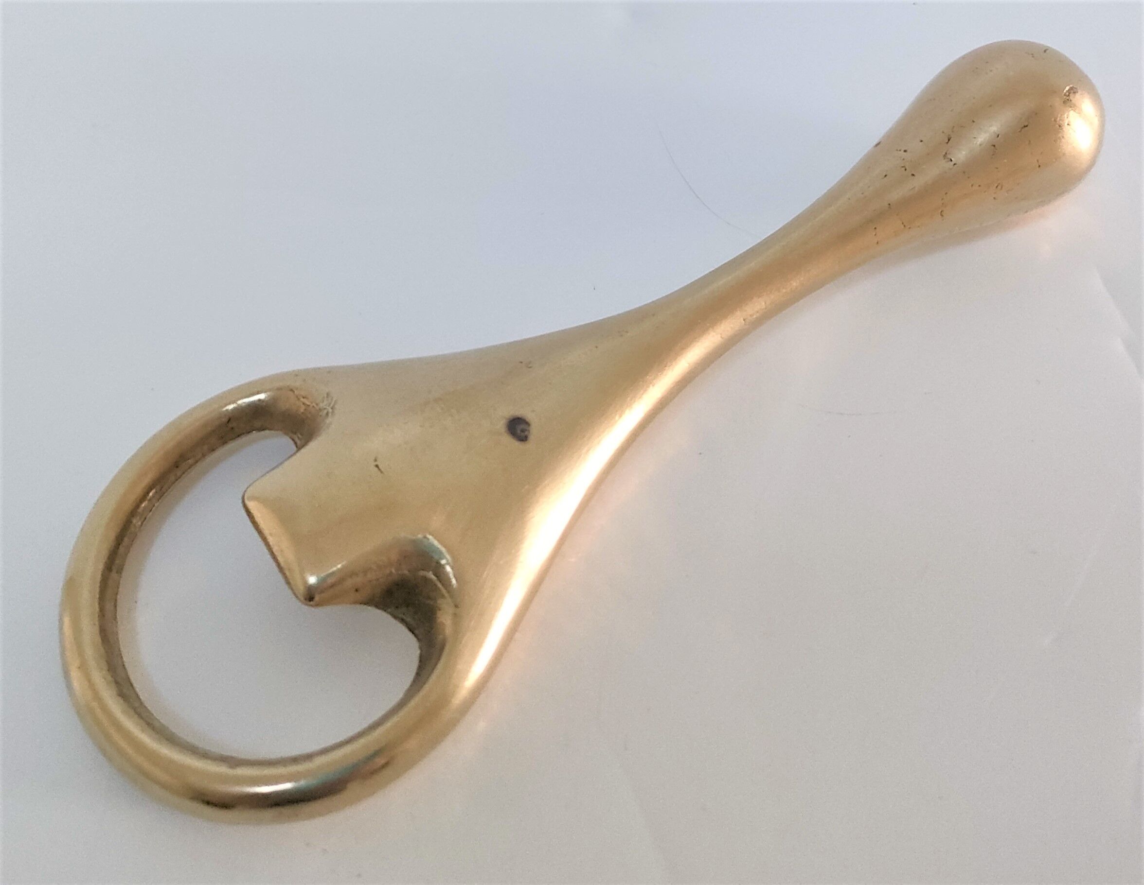 Modernist solid brass bottle opener by Carl Auböck