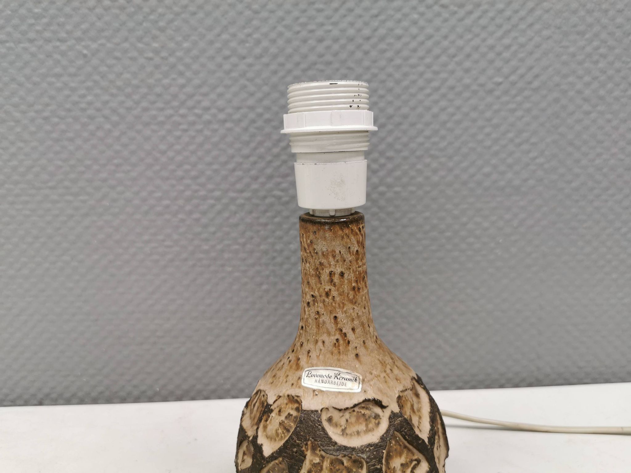 Small beautiful ceramic table lamp in earth colors.