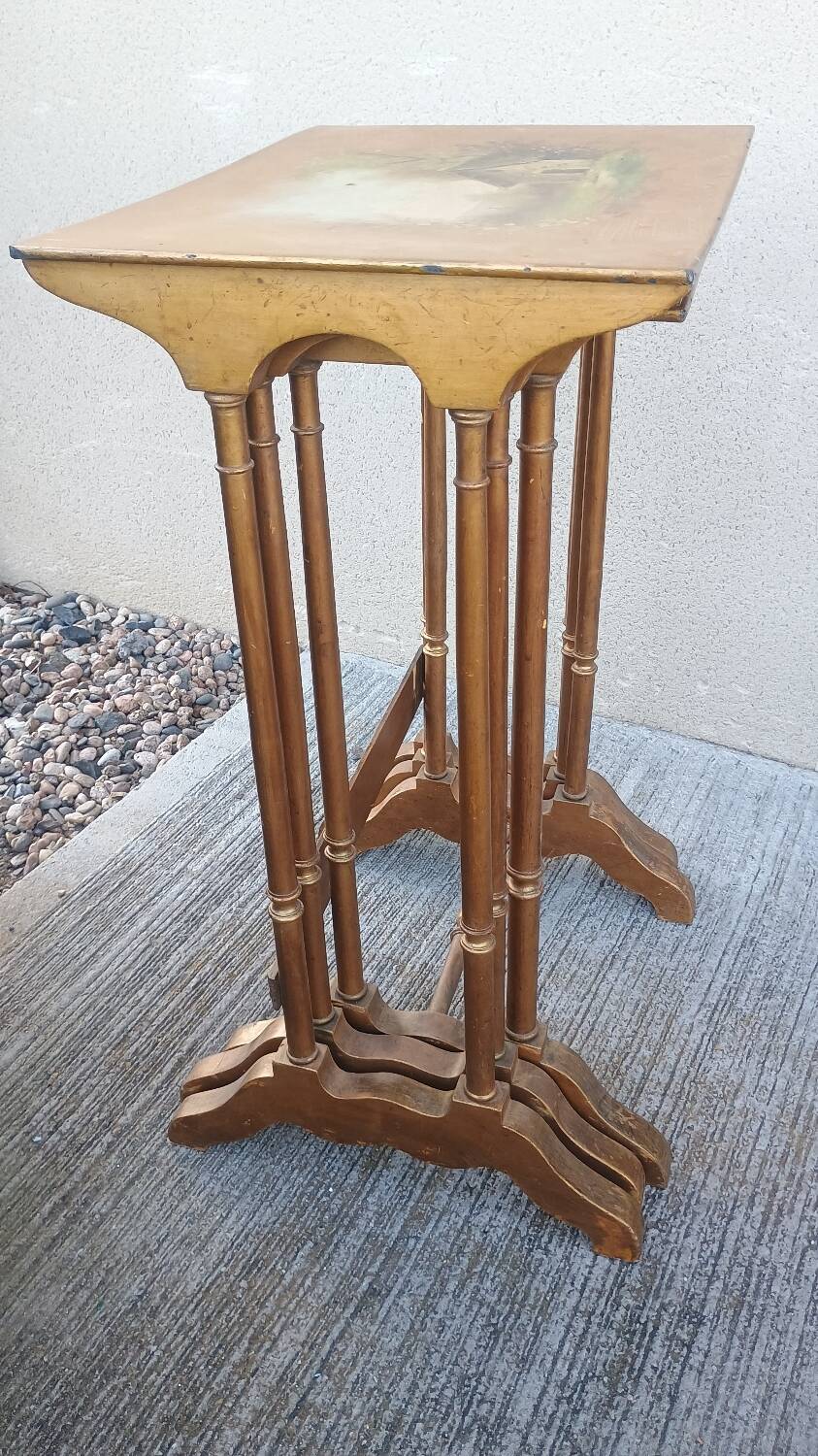 Sets of three nesting tables with painted landscape decorations in poplar.