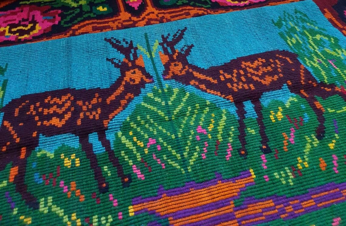 Vintage Romanian rug with deers, nature scenery on a floral background
