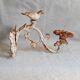 Wall lamp in antique cast iron with bird and scroll decorations.