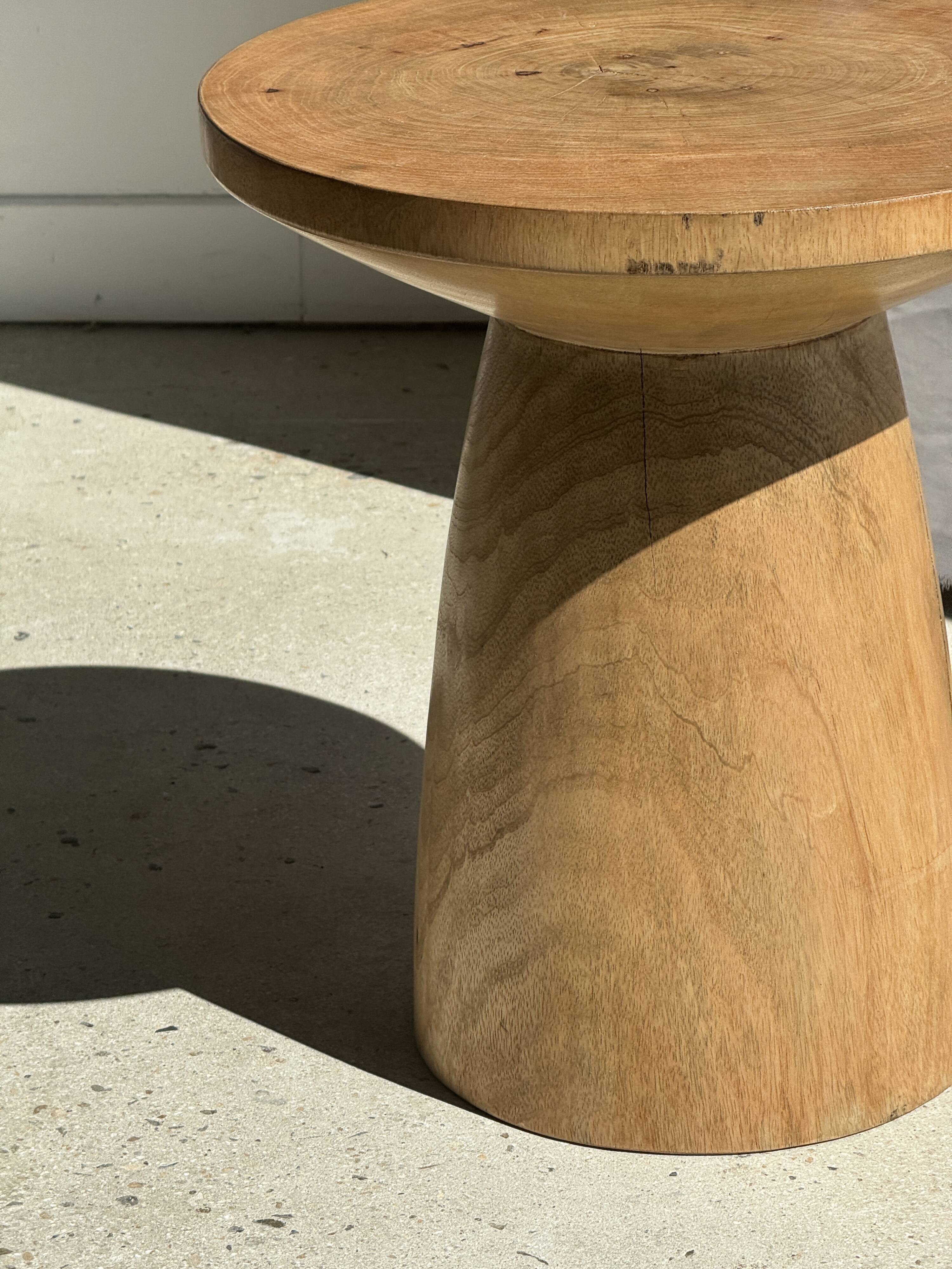 Natural solid mango side table (monoxyle) with conical legs.