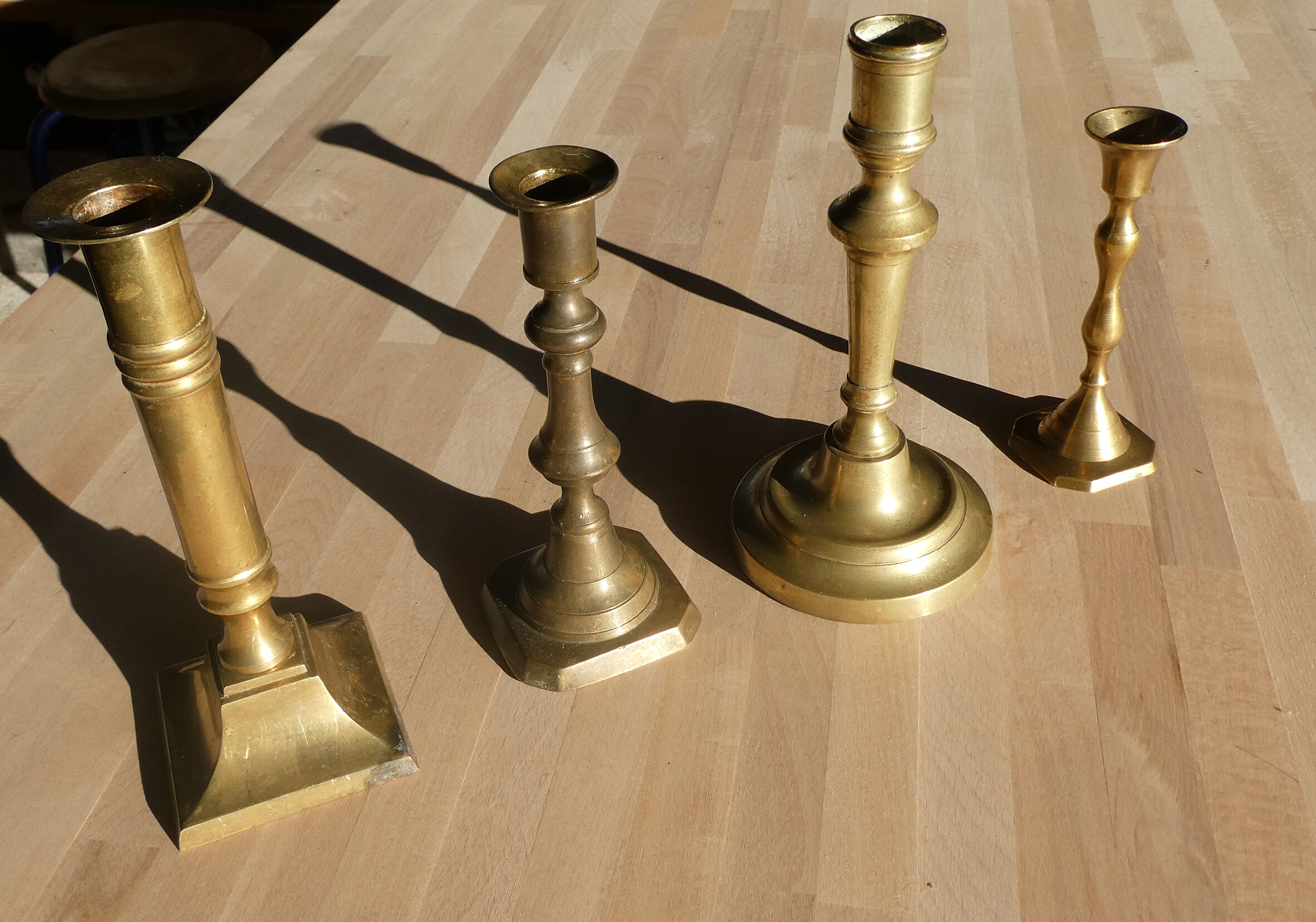 Set of 4 old candle holders in golden brass