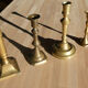 Set of 4 old candle holders in golden brass