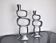 Pair of circle candlesticks by matthew hilton, england, 1980