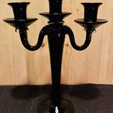 Set of four black glass candle holders.