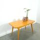 Vintage veneer table with pretty angular legs and brass at the base of the legs.