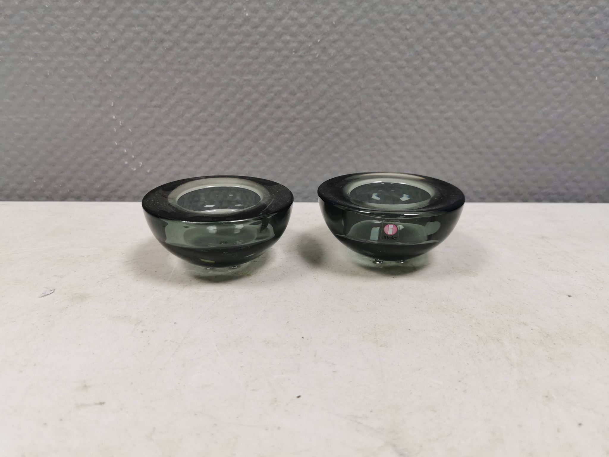A set of iitalla candle holders in smoked transparent glass.