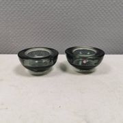 A set of iitalla candle holders in smoked transparent glass.