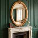 Gold oval mirror refurbished with a pediment — Louis XVI / Napoléon III style