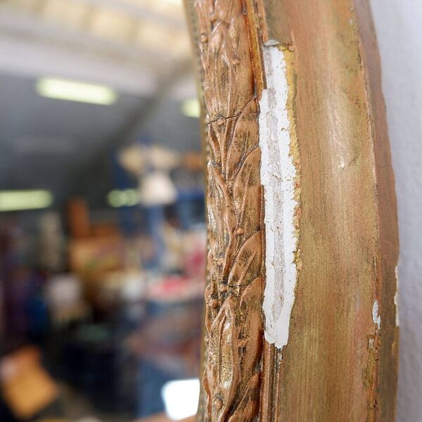 Wear consistent with age and use  Wood and gilded plaster ''Noeud d'Amour'' Oval mirror