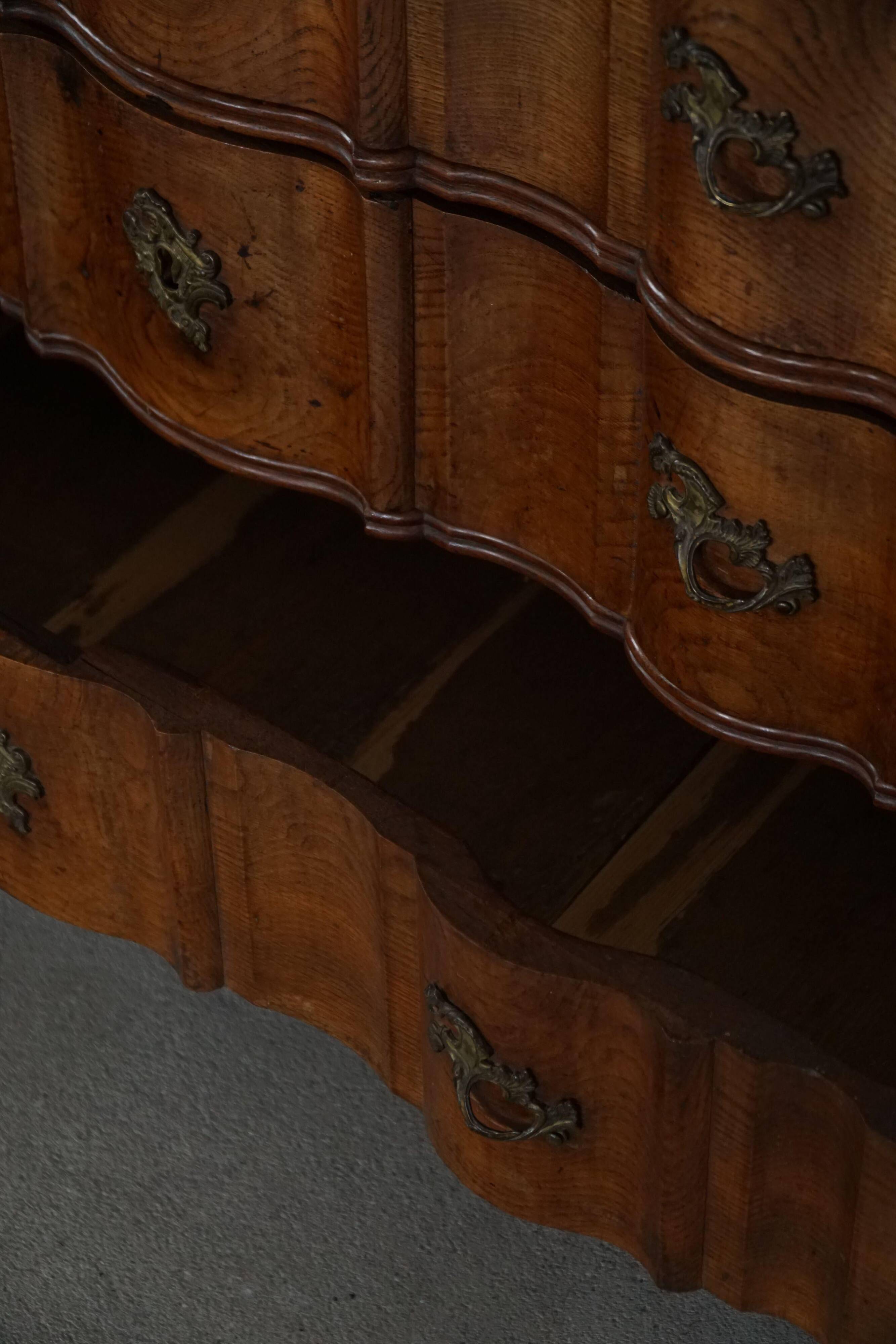 Antique baroque oak commode from the late 18th century with cabriole legs.