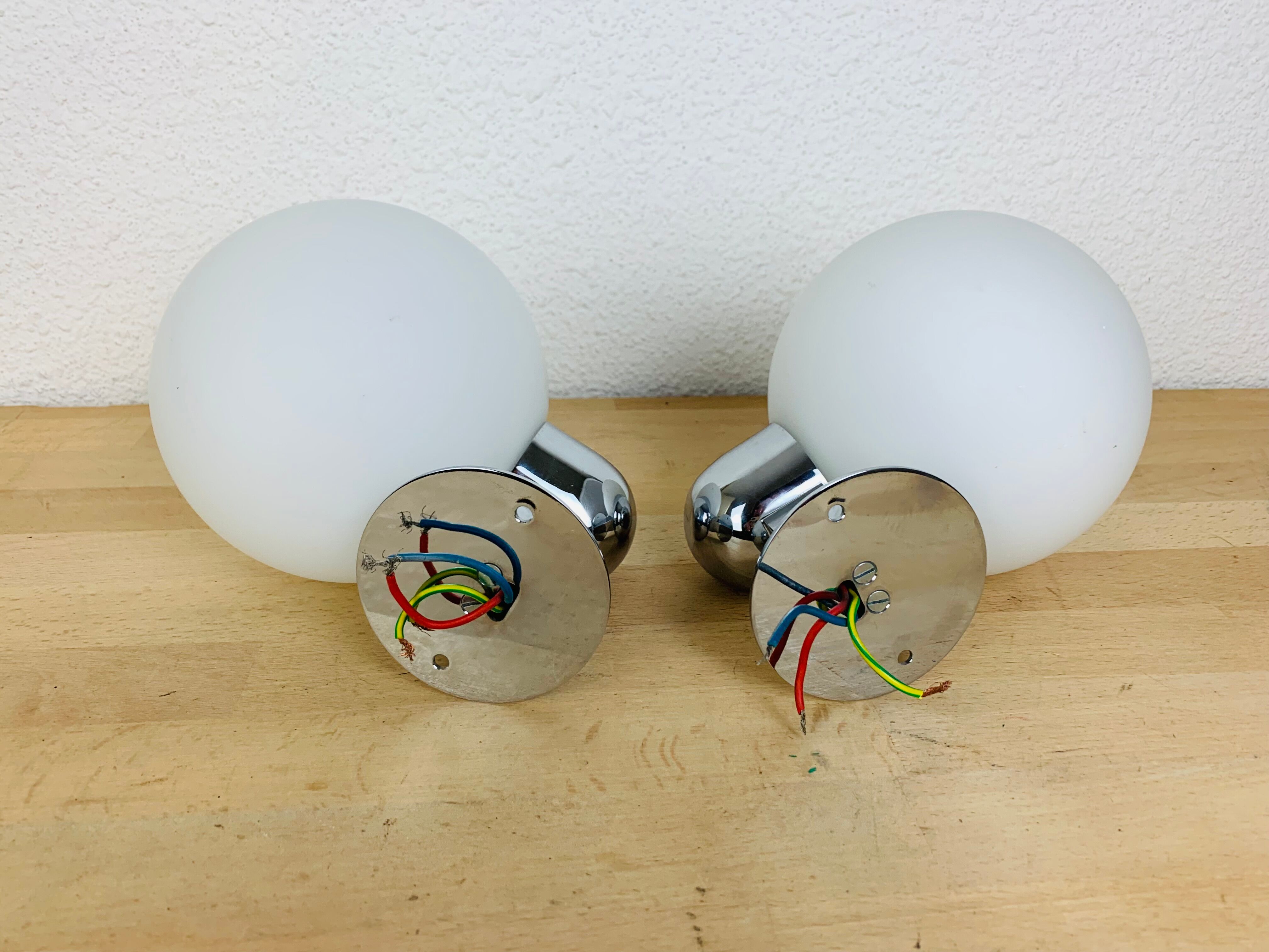 Pair of wall lamps space age chrome and opal globe 70s