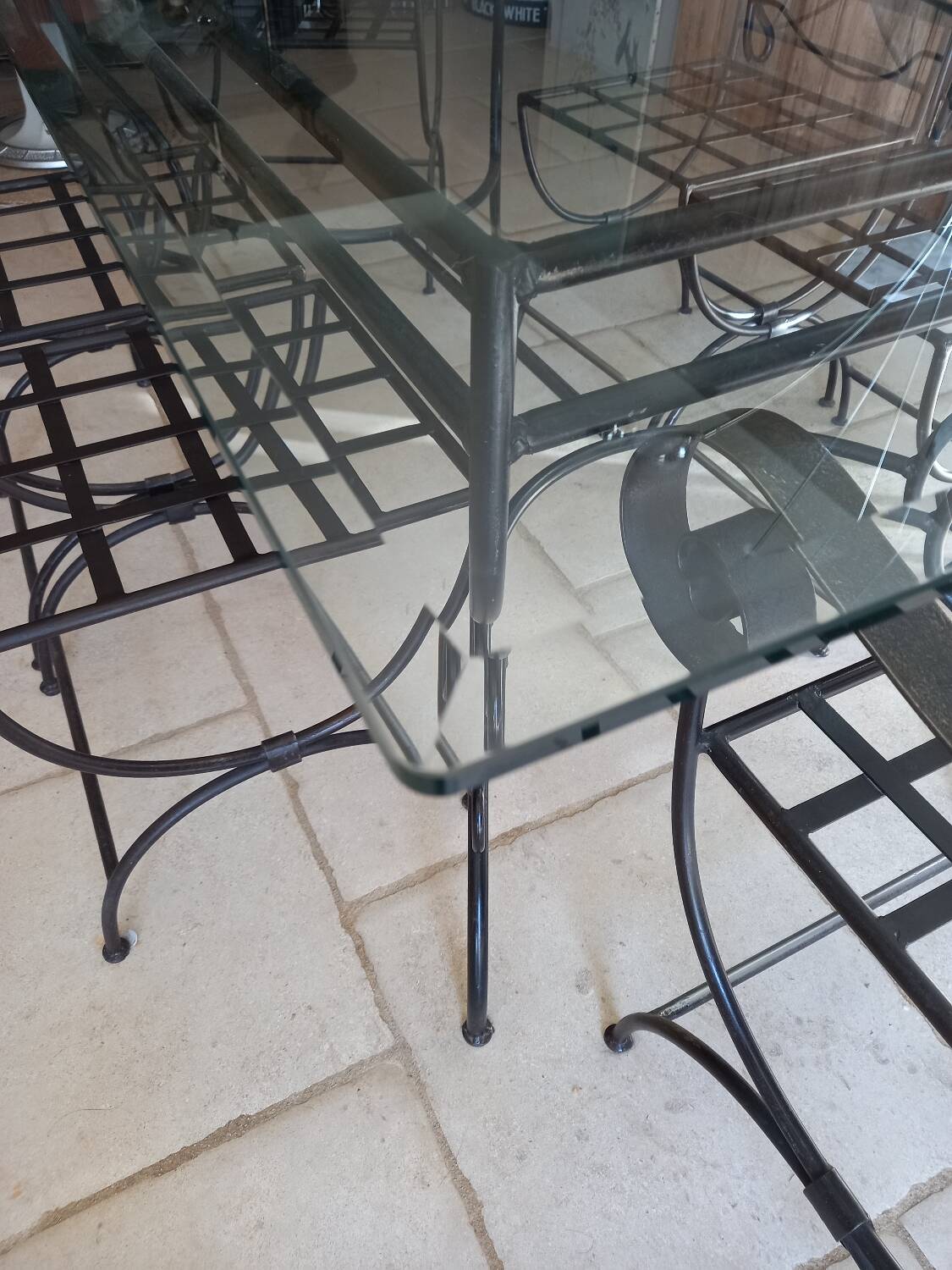 Glass table and wrought iron chairs