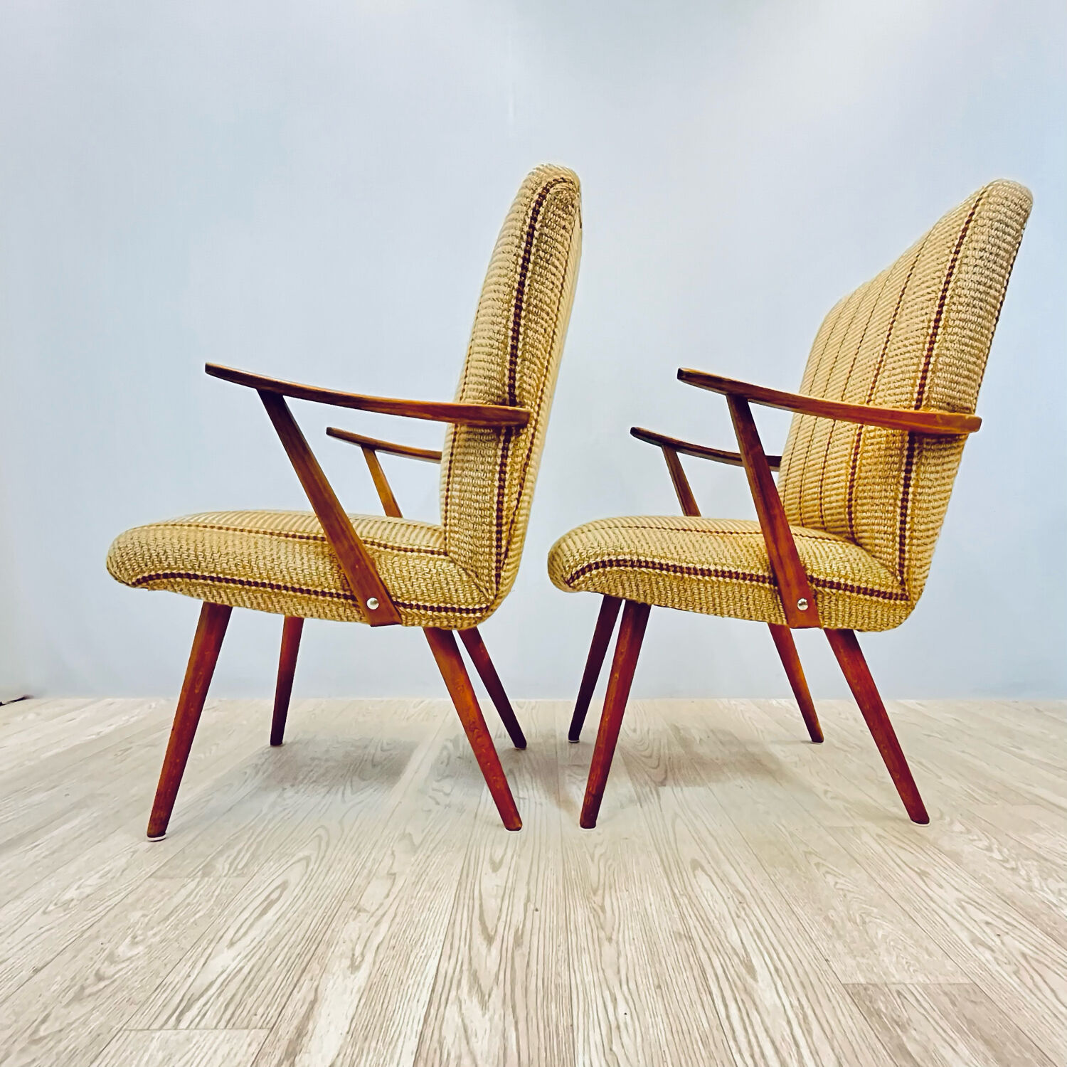 A pair vintage cocktail chairs with stripes and metal screws