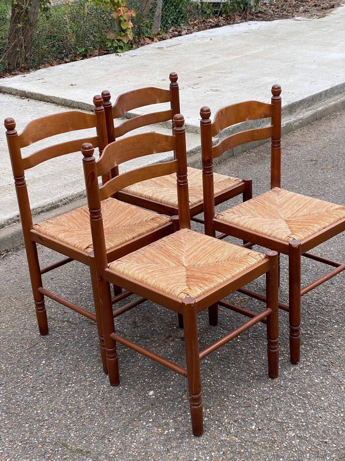 4 dining or kitchen chairs made of solid wood with rush seats.