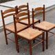 4 dining or kitchen chairs made of solid wood with rush seats.
