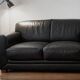 Leather sofa and armchair in black cowhide, brand Steiner.