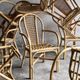 Set of 8 Manou rattan chairs with cane backrest.