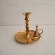 Old candlestick with brass extinguisher.
