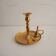 Old candlestick with brass extinguisher.