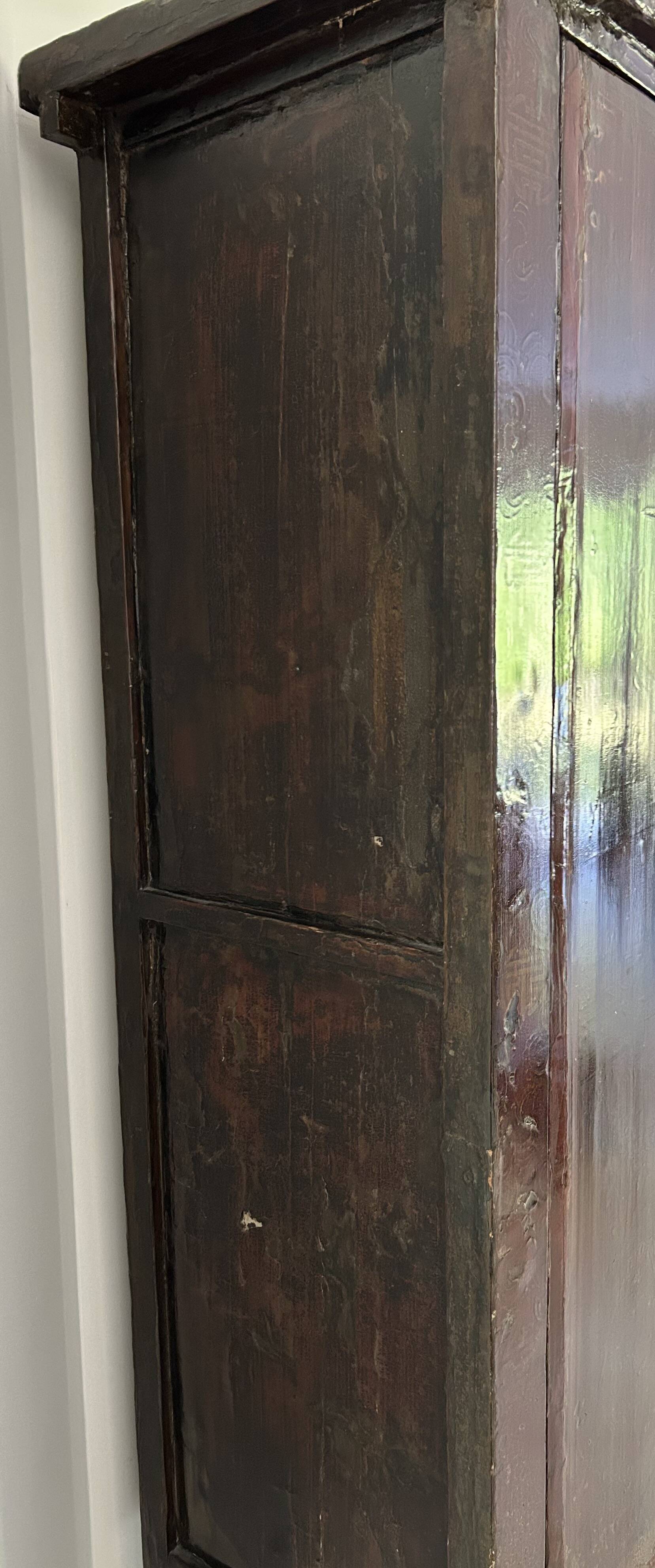 Antique Chinese wardrobe in carved elm.