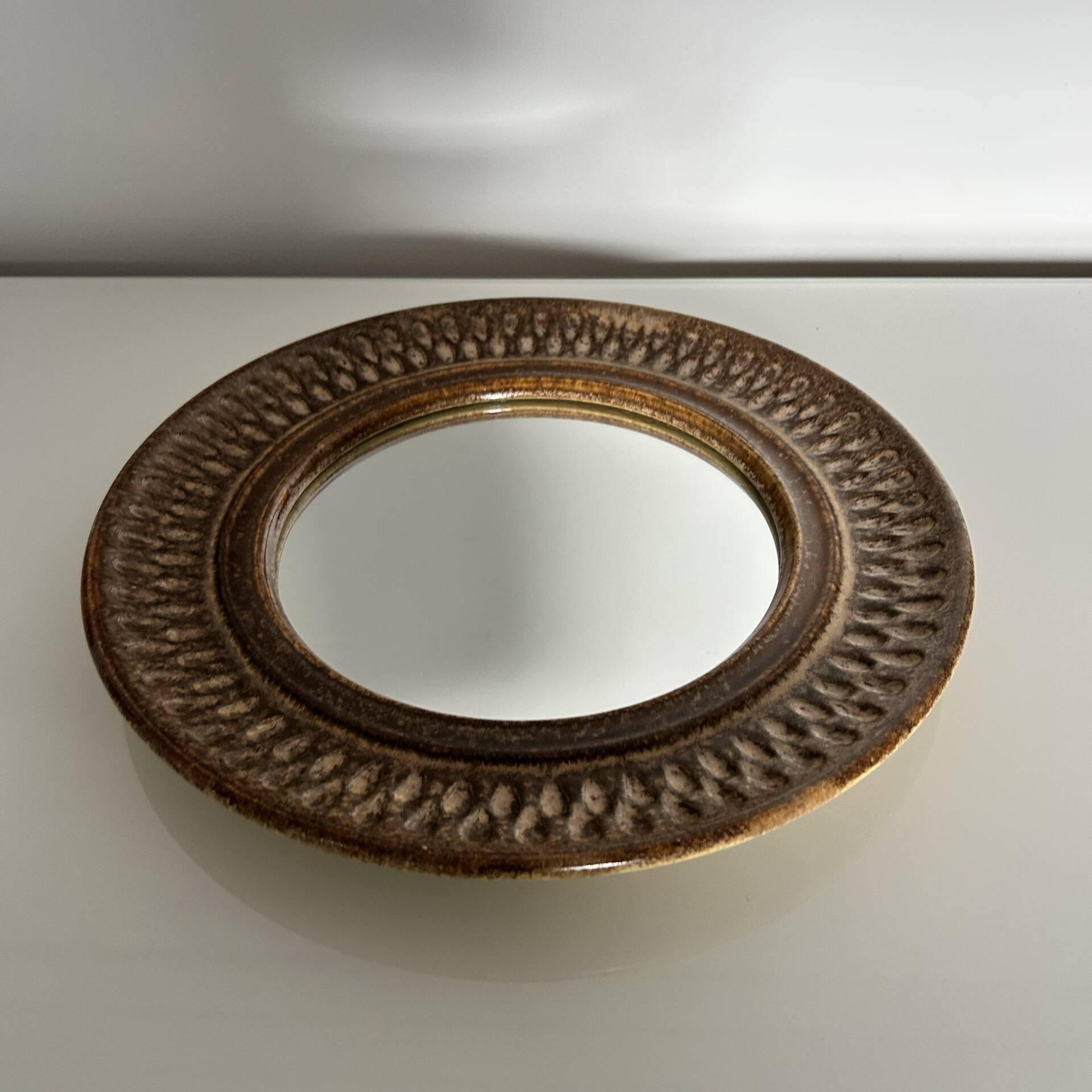 Chiselled stone mirror