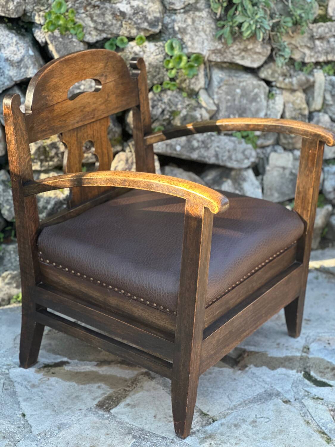 Pair of armchairs in stained wood and leather, 20th century