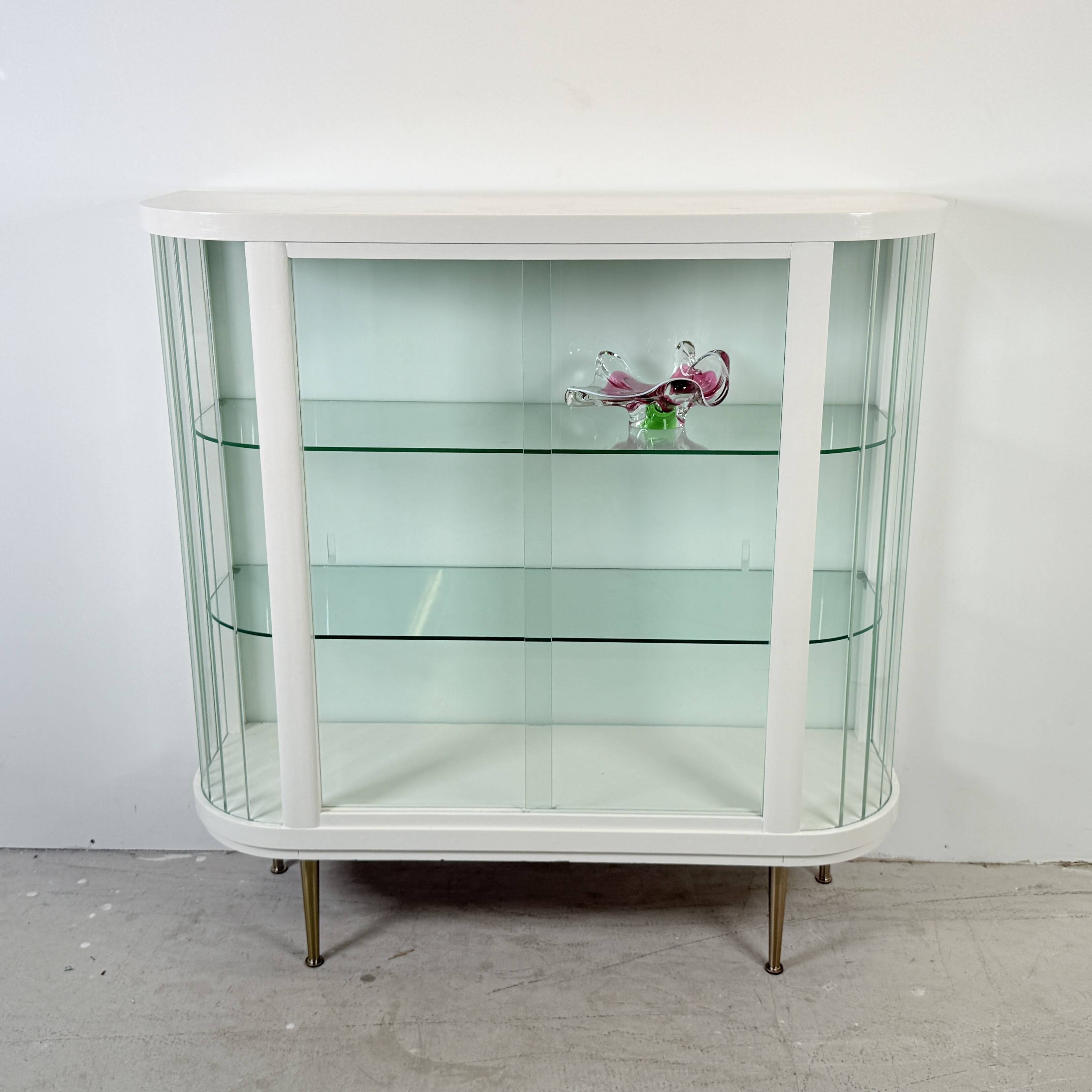 White vintage slatted display case on gold legs