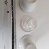 Three white porcelain and glass inkwells for school desk